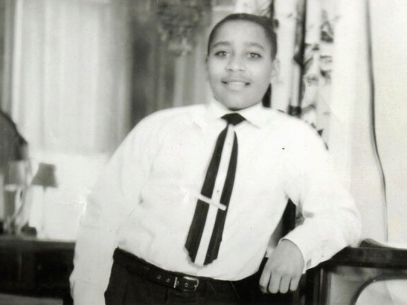Emmett Till leaning against a piece of home furniture