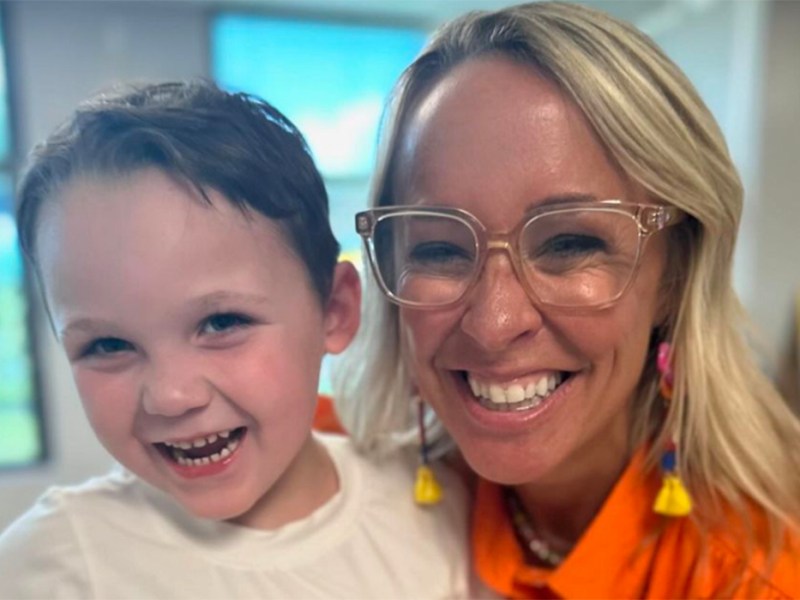 A little boy and woman smiling together