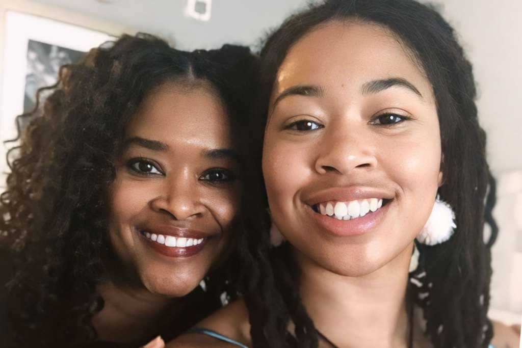 Two women smile while posed together for the camera