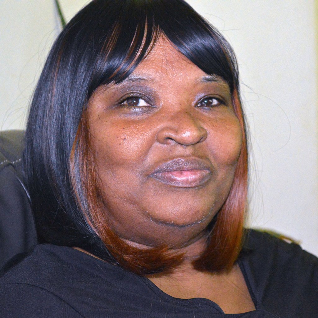 headshot of Black woman with smile and black pageboy haircut