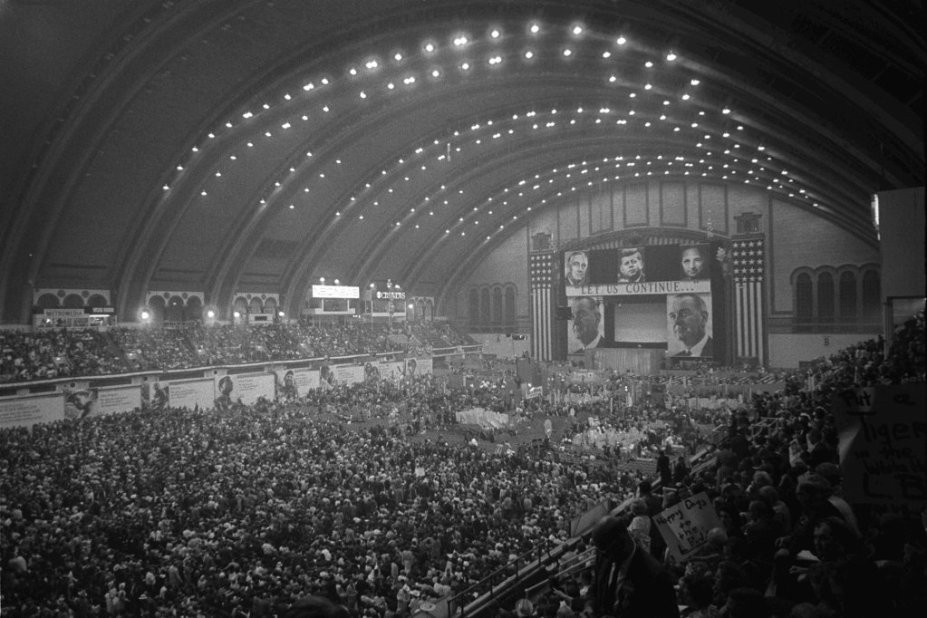 Very wide shot of the interior of Convention Hall, looking toward the speaker's platform; the hall is packed with delegates on the floor and oberservers in the balconies.