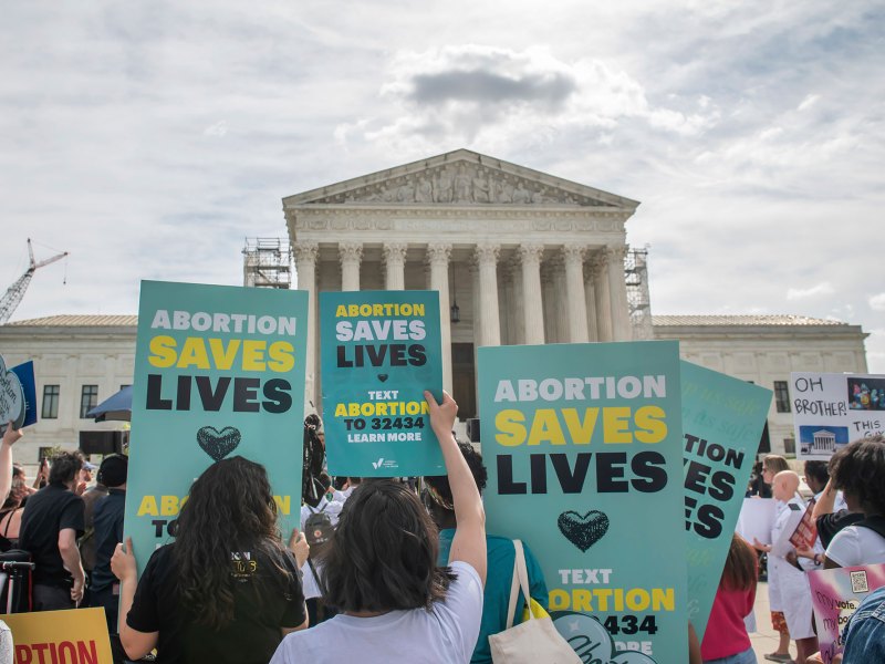 A crowd holds an "abortion is healthcare" rally in front of the Supreme Court