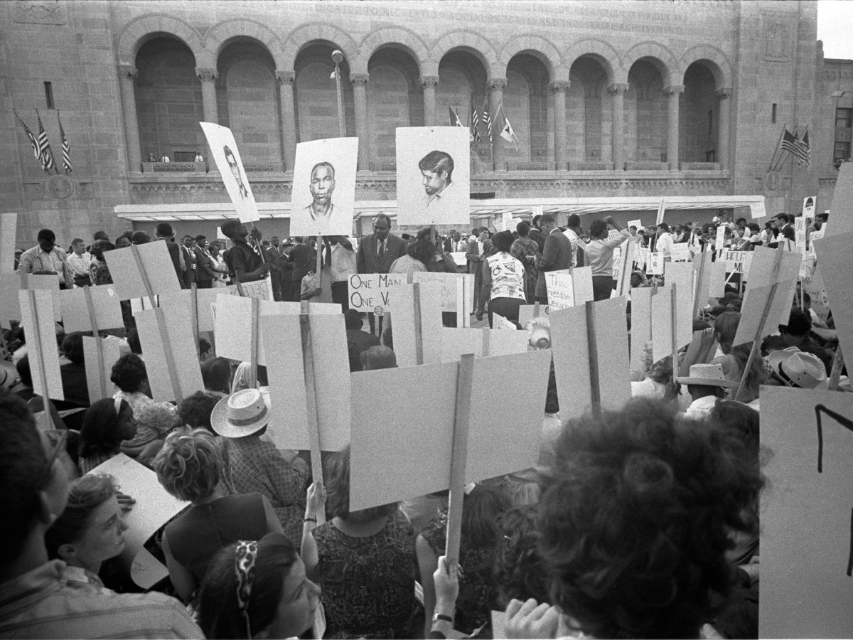 African American and white Mississippi Freedom Democratic Party supporters demonstrating outside the 1964 Democratic National Convention, Atlantic City, New Jersey; some hold signs with portraits of slain civil rights workers James Earl Chaney, Andrew Goodman, and Michael Schwerner