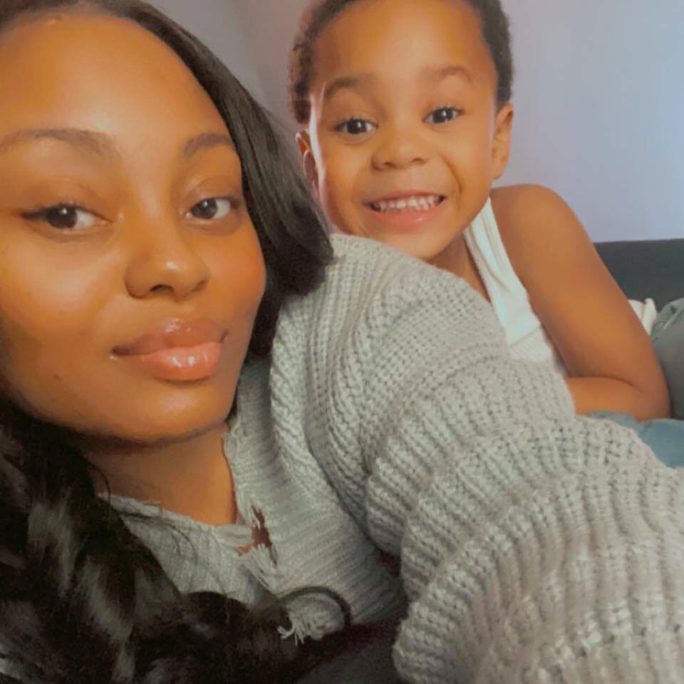 A selfie of a woman and her young son, smiling