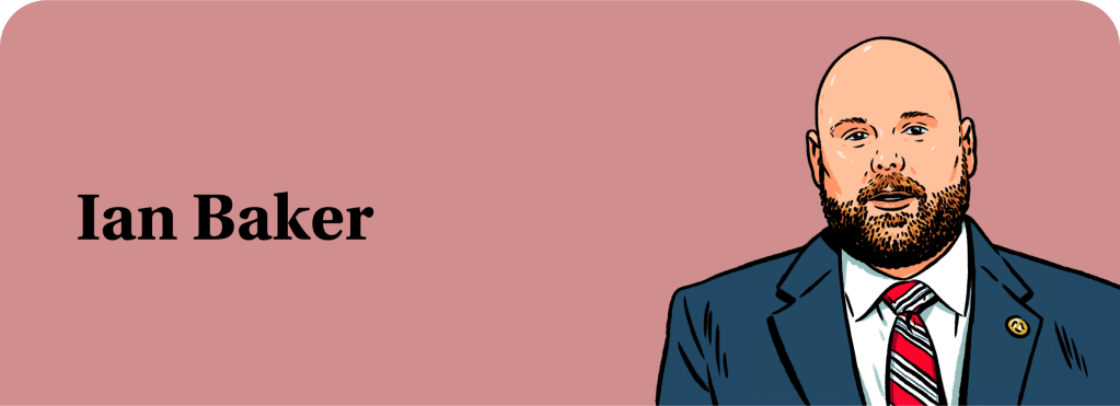 An illustration of Ian Baker, a bald White man with a beard, wearing a suit and tie.