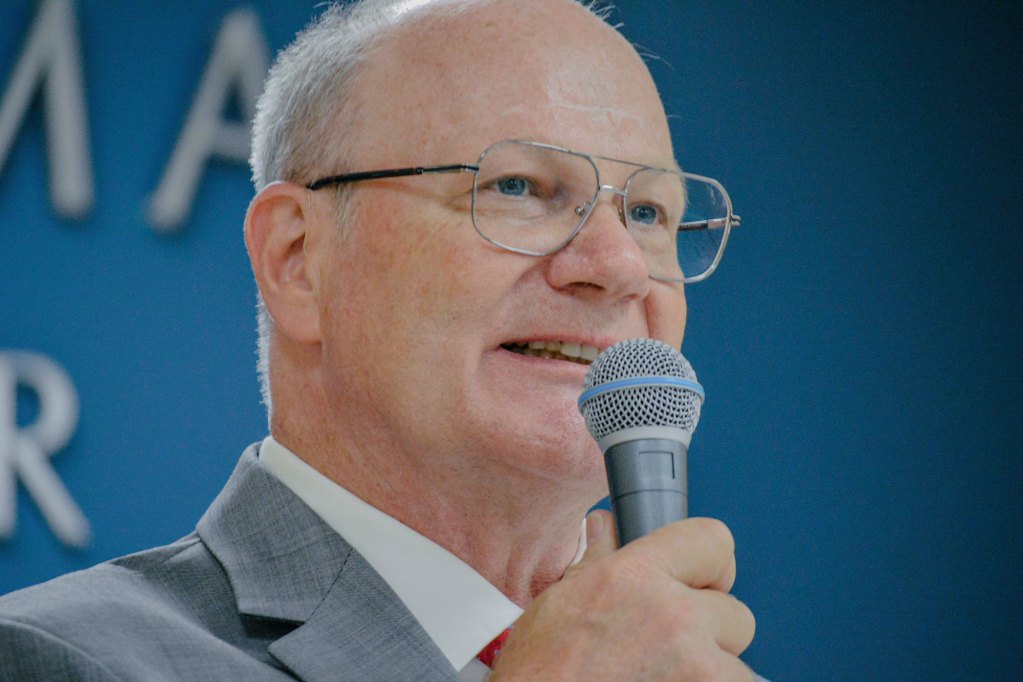 a photo of Ron Eller holding a microphone