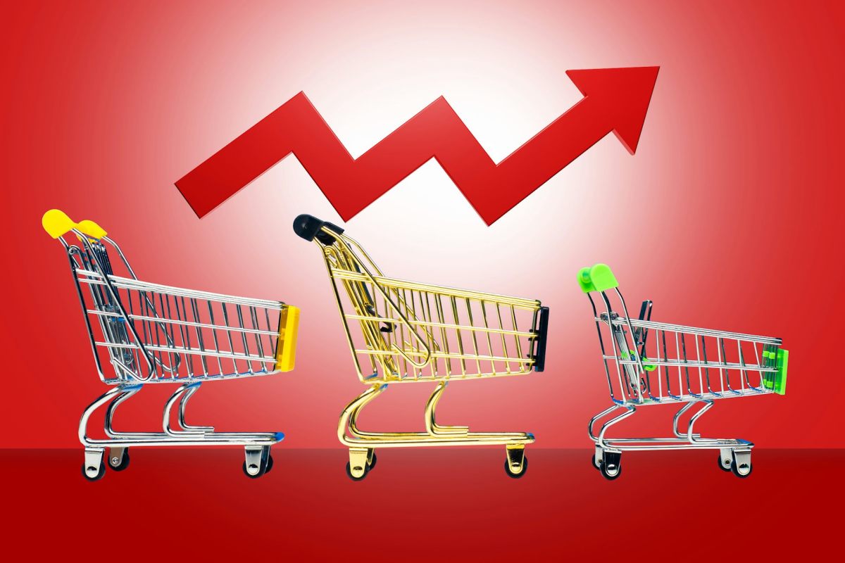 A graphic of three shopping carts against a red background, with a red arrow zig zagging up