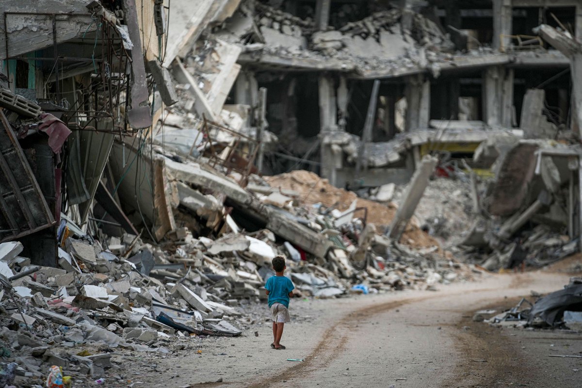 A child walks through the destruction left by the Israeli air and ground offensi