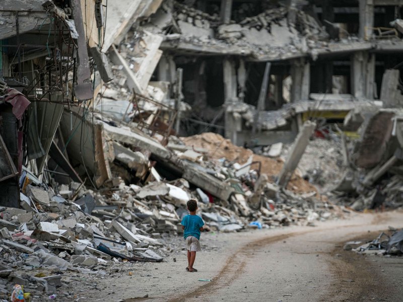 A child walks through the destruction left by the Israeli air and ground offensi