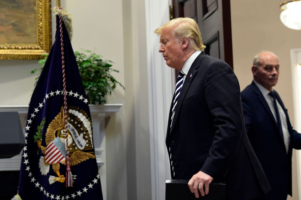President Donald Trump walks in to the Roosevelt Room of the White House in Washington, Thursday, Nov. 1, 2018, to talk about immigration and border security. Chief of Staff John Kelly is at right.