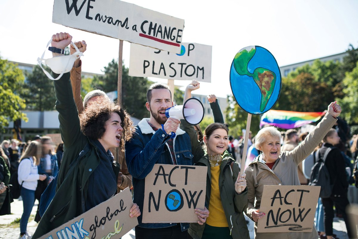 People at a protest holding signs about climate change