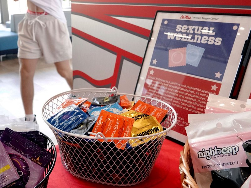 Condoms and other sexual wellness items are made available to students on a red table