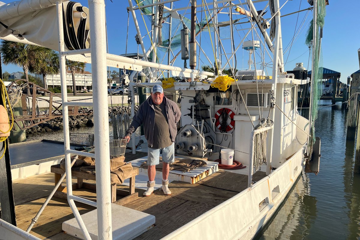 White men culling oysters on a boat
