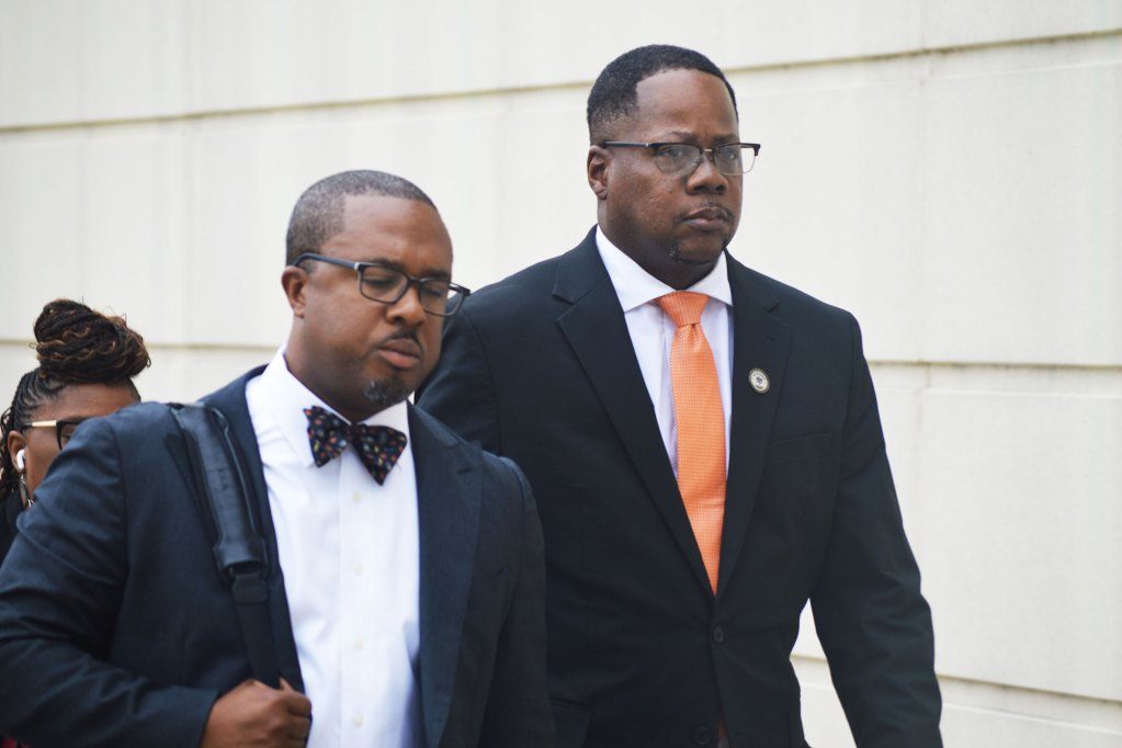 a photo of aaron banks walking into a courthouse