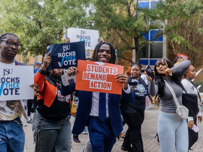 JSU students on plaza holding election signs