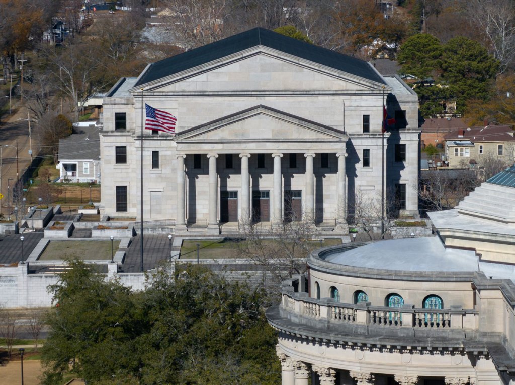 An aerial photo of the Mississippi Supreme Court, a gray stone building with a triangle roof and columns at the entrance.