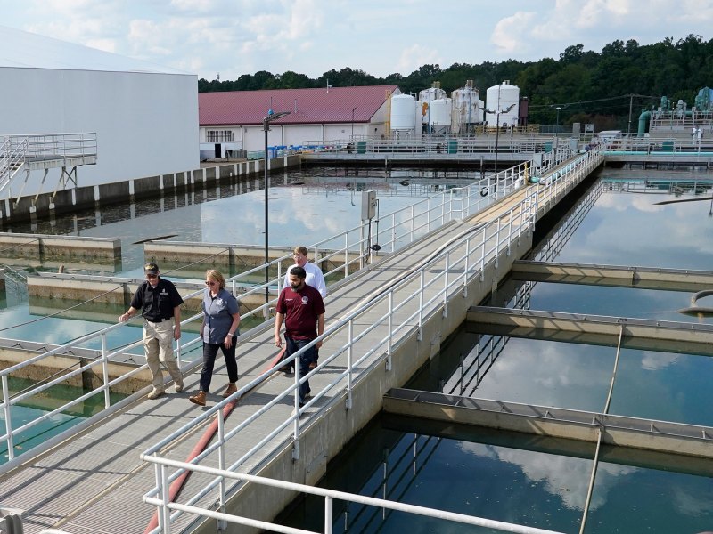 State and City officials walk past sedimentation basins at the City of Jackson's O.B. Curtis Water Treatment Facility