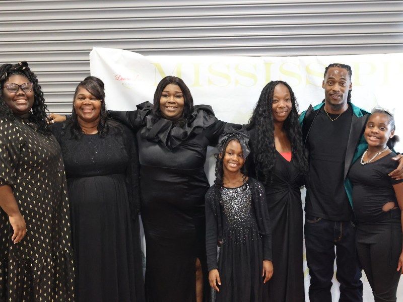 Black family at red carpet event.