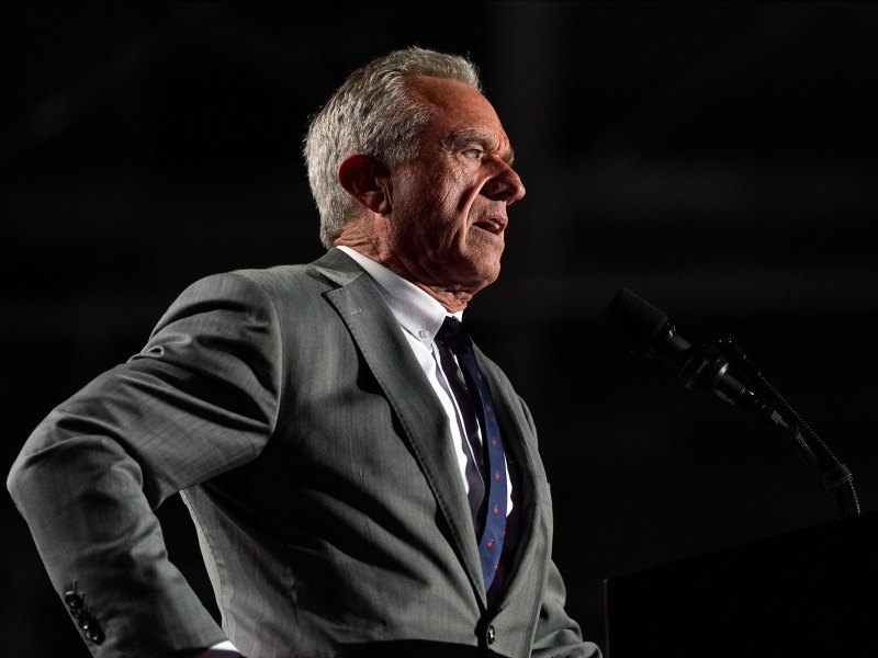 Robert F. Kennedy Jr., speaks on a dark stage