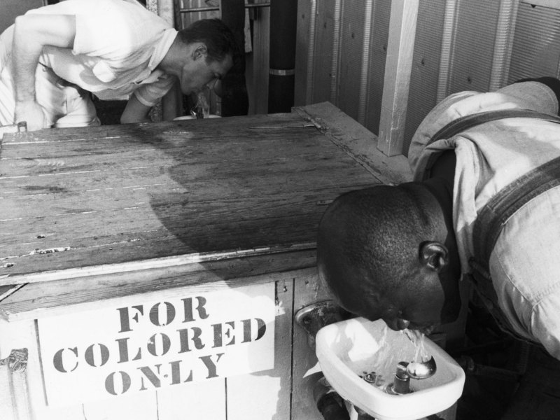 Segregated drinking fountain in use in the American South