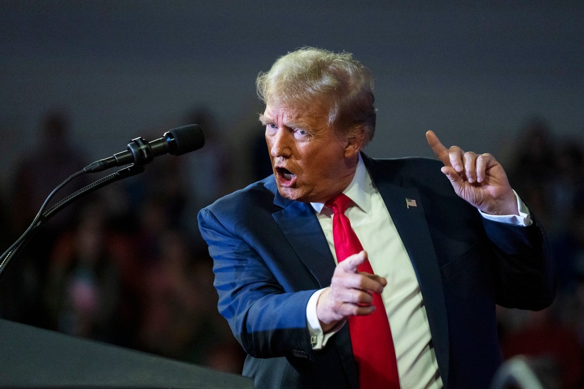 a photo of Donald Trump looking angry at a microphone