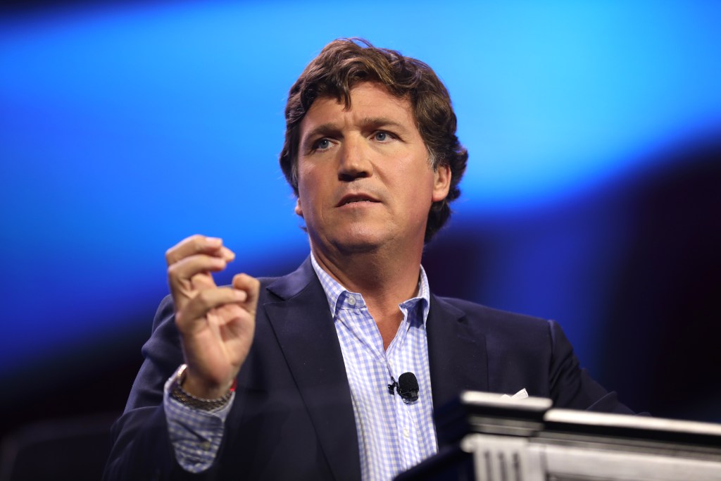Tucker Carlson speaking at conference in West Palm Beach, Florida.