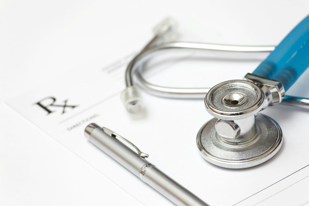 A stethoscope, pen and prescription pad.