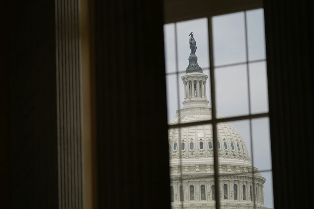 A view of the US Capitol dome through a window.
