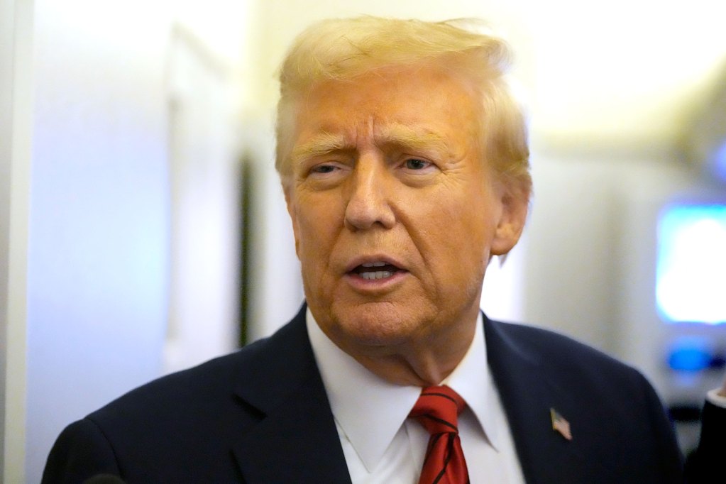 Closeup of a man in a suit and US flag pin on the lapel, speaking