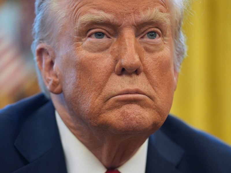 A closeup of President Donald Trump listening to a question