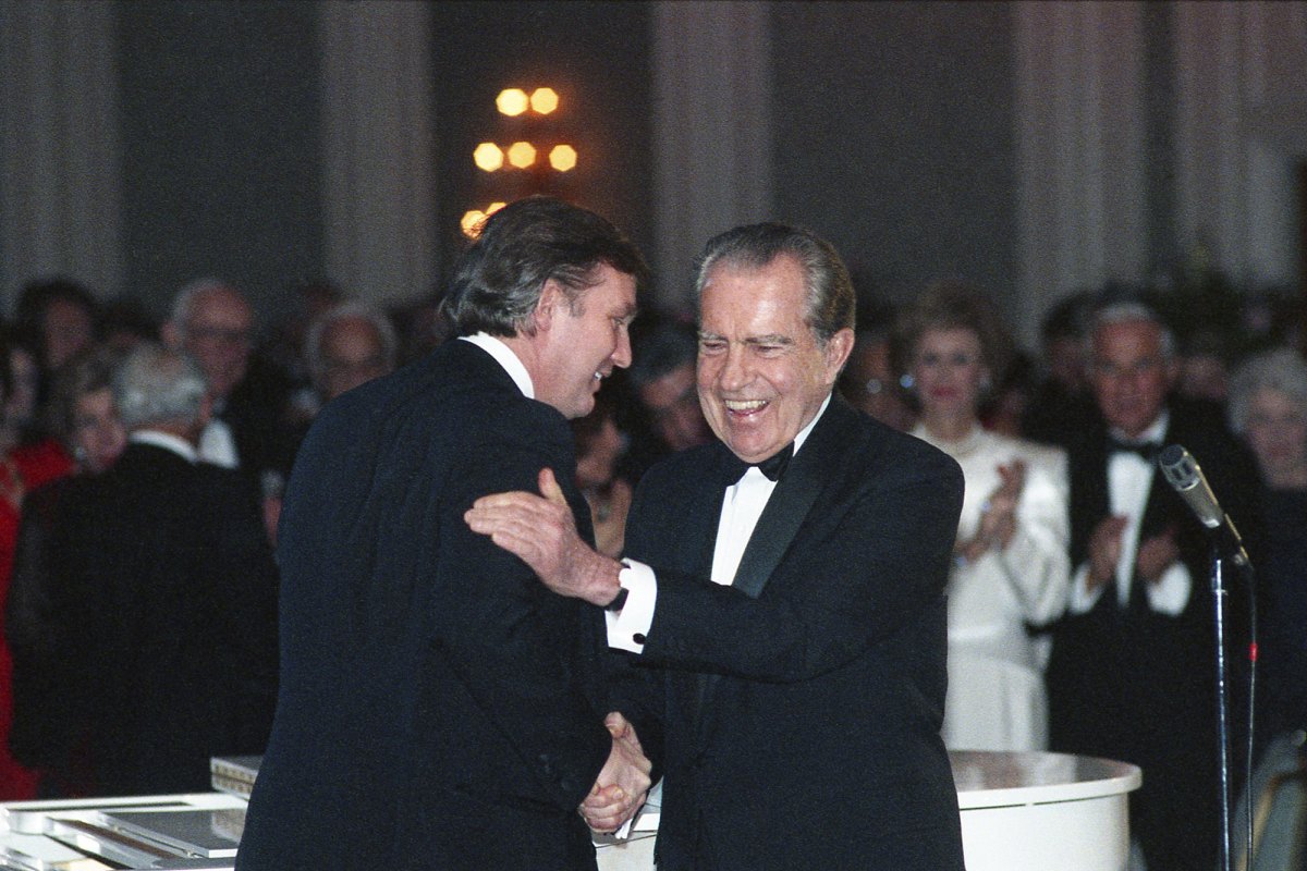 Donald Trump and Richard Nixon shake hands at a public event