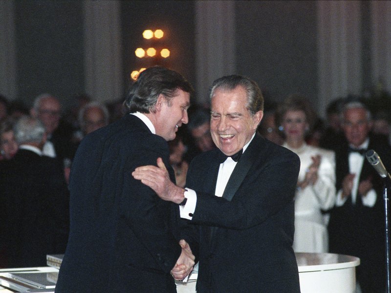 Donald Trump and Richard Nixon shake hands at a public event