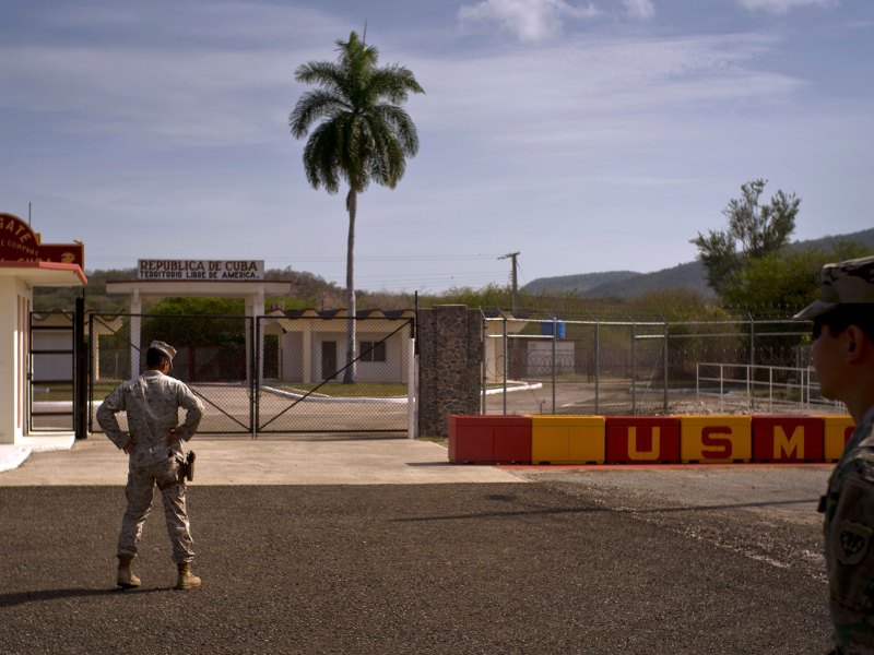 Two soldiers stand outside a military base on Cuba