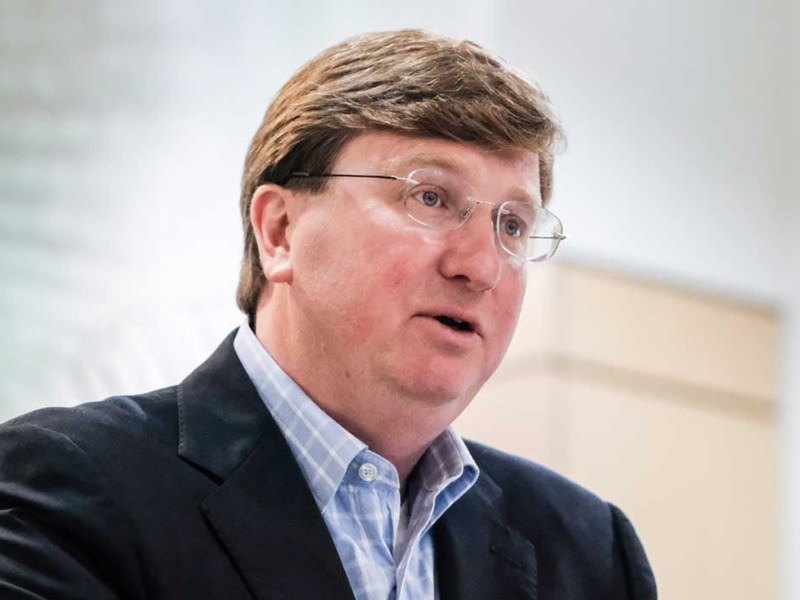 A man in glasses and a suit speaking