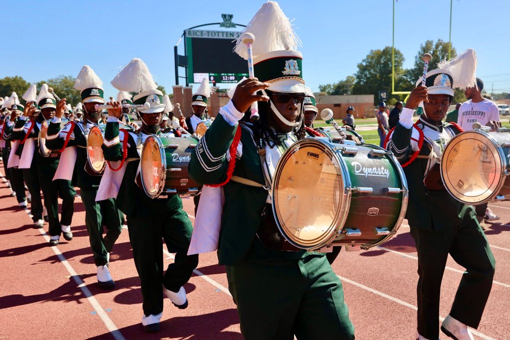 Mississippi Valley State University Band performing on the track around a football field