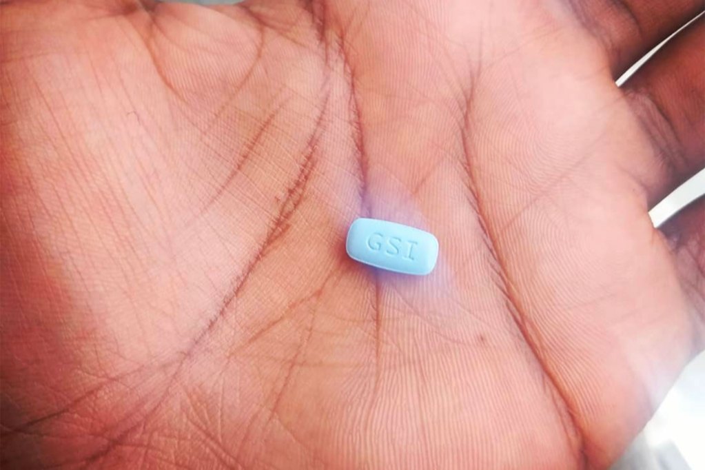 A small blue pill that reads GSI sits in the palm of a hand