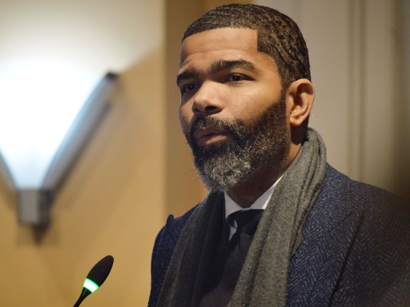 A man speaking at a meeting