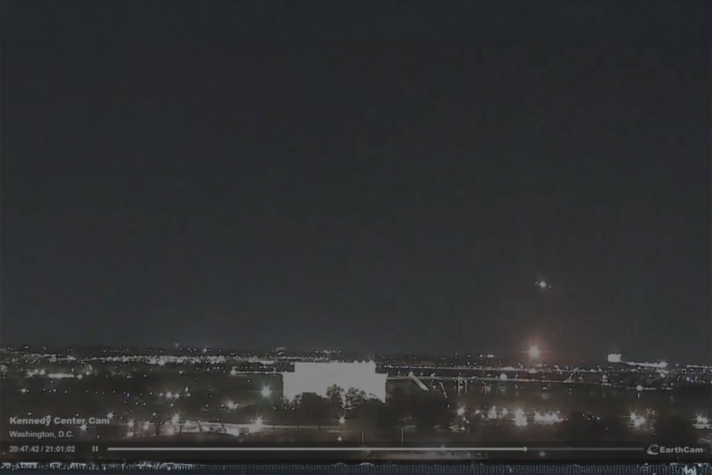 A still from a nighttime video of a skyline showing a small explosion to the bottom right