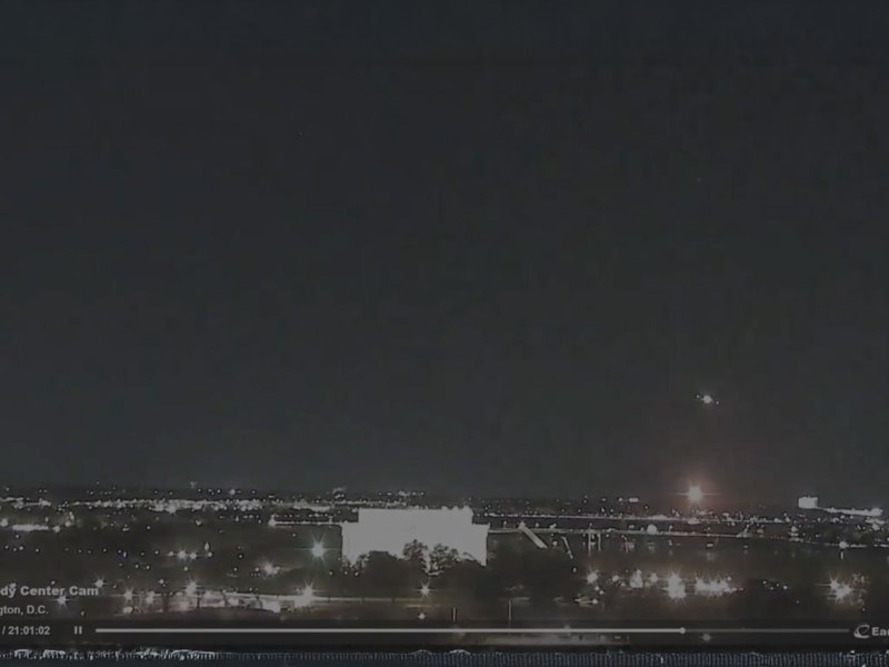 A still from a nighttime video of a skyline showing a small explosion to the bottom right