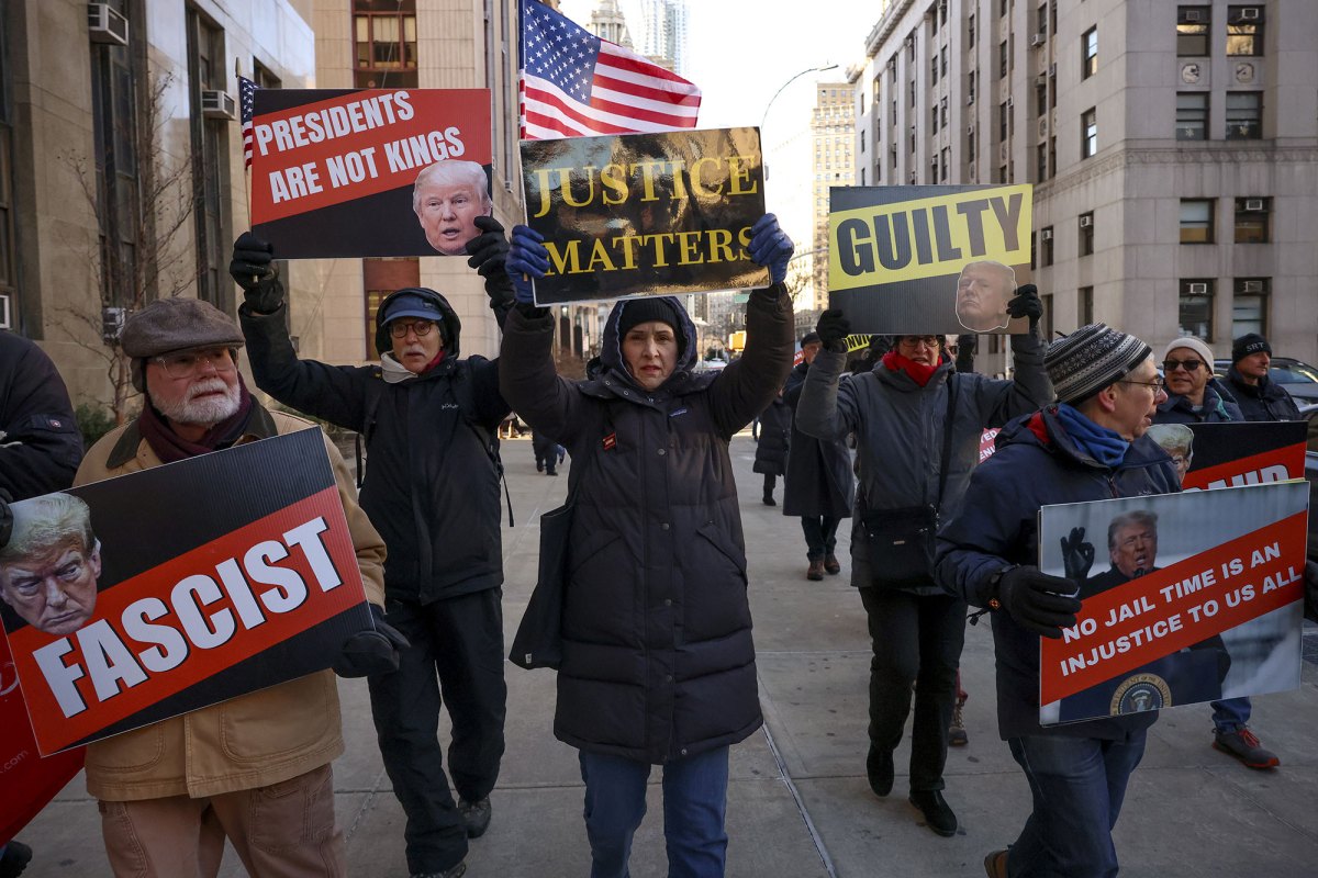 Demonstrators protest outside Manhattan criminal court with sings that read "Presidents are not kings" and "Justice mattters"