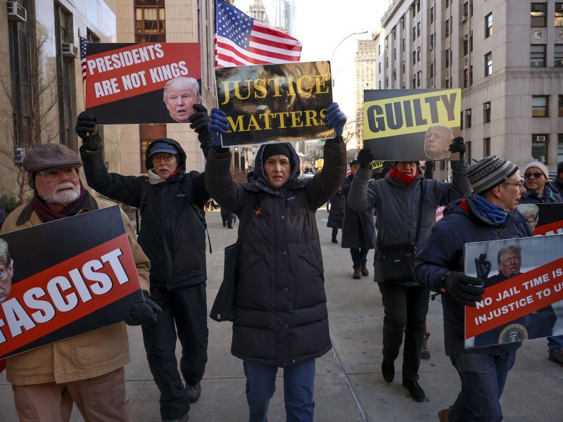 Demonstrators protest outside Manhattan criminal court with sings that read "Presidents are not kings" and "Justice mattters"