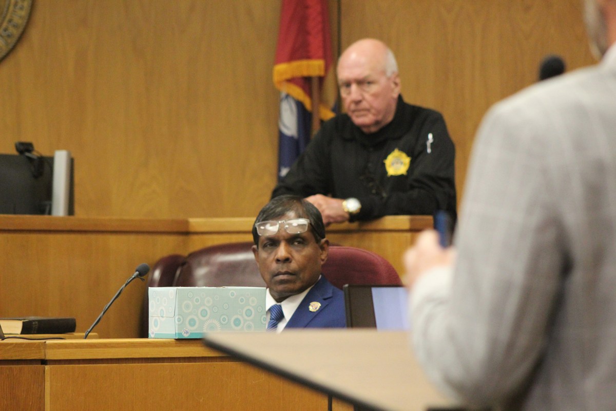 Man in court with glasses on his forehead