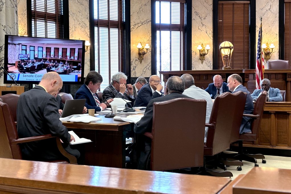 A table full of men in suits at a meeting