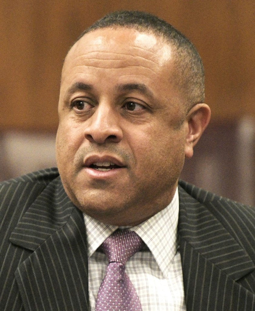 Closeup of a man in a black pinstripe suit