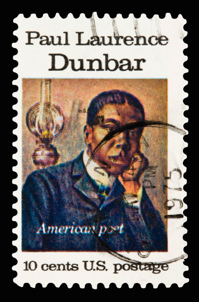A postage stamp bearing the image of a black man resting his chin on his hand.