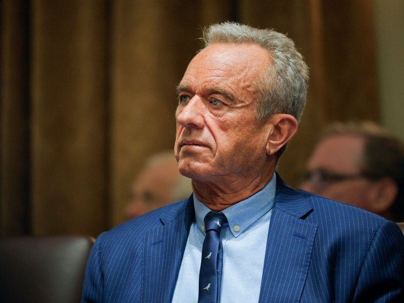 Closeup of an older man in a blue suit and tie
