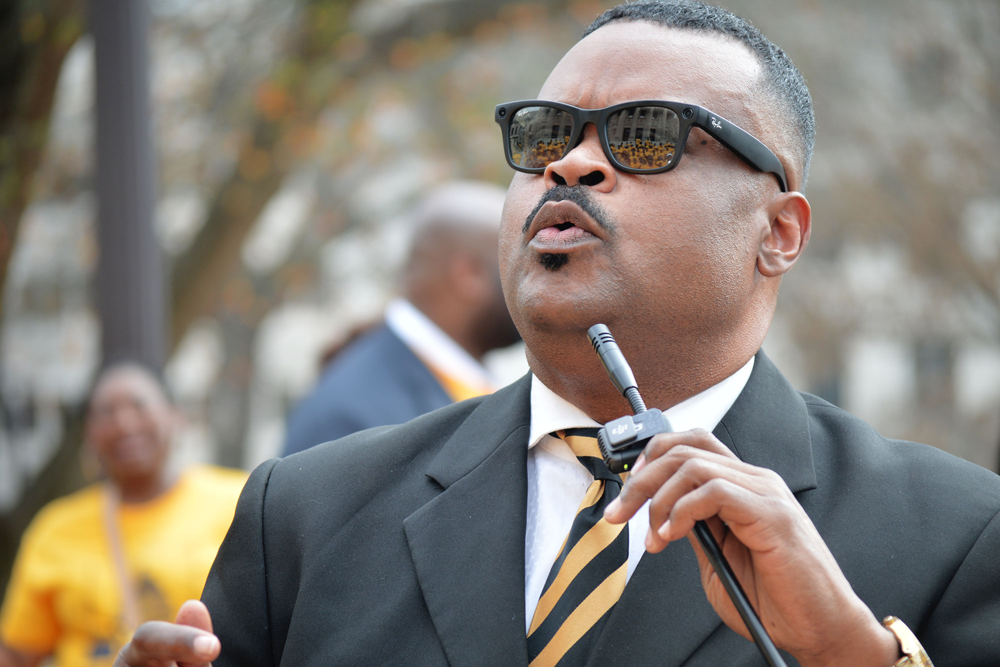 Kamir Karriem holding a microphone and speaking 