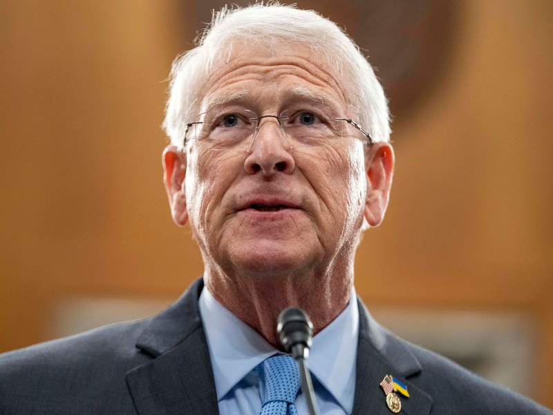 Closeup of a Roger Wicker in a suit speaking at a mic