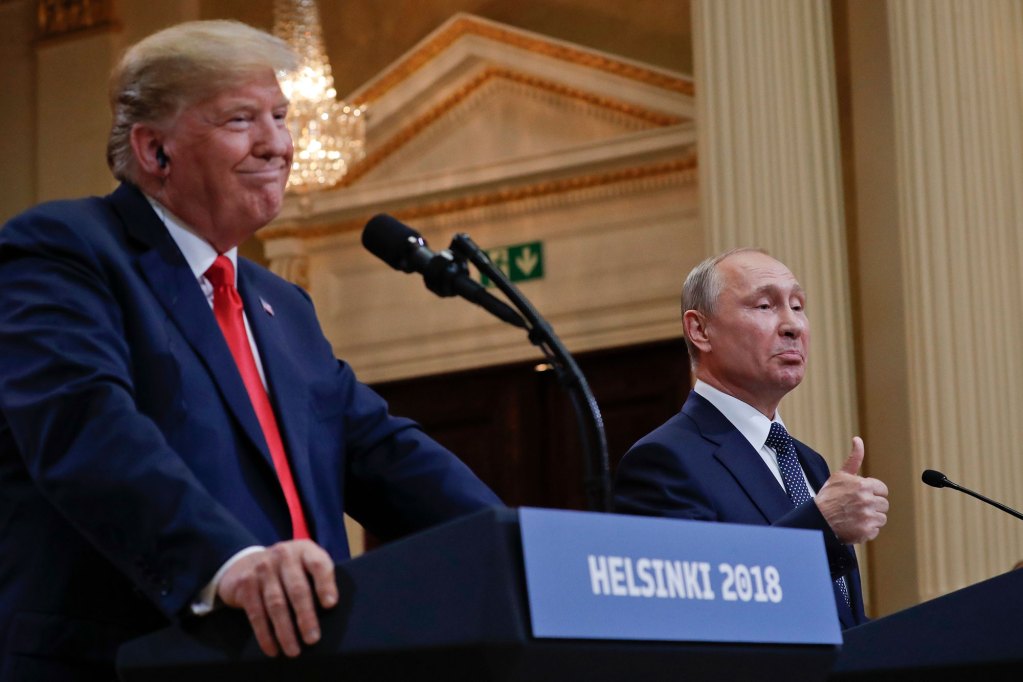 Two men stand behind podiums labeled Helsinki 2018