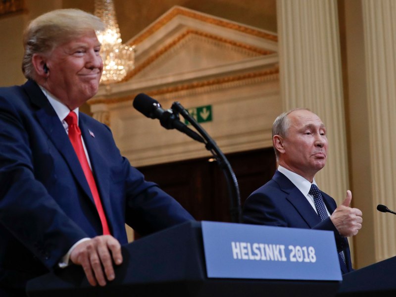 Two men stand behind podiums labeled Helsinki 2018